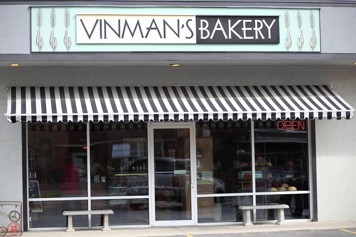The seafoam-green Vinman's Bakery storefront sign with striped awning