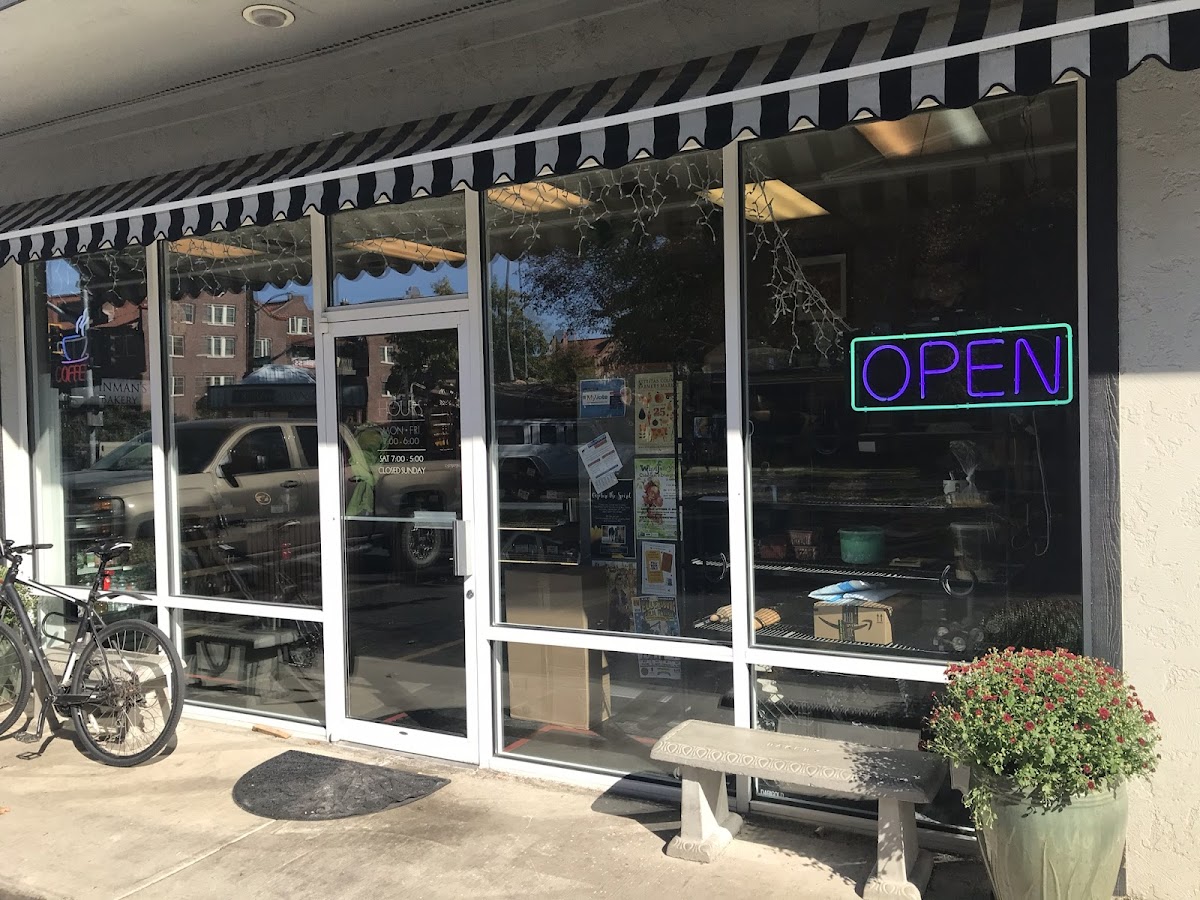 The striped awning storefront with neon OPEN sign